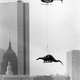 Illustration for article titled A Curious Photo of a Dinosaur being Airlifted over Boston